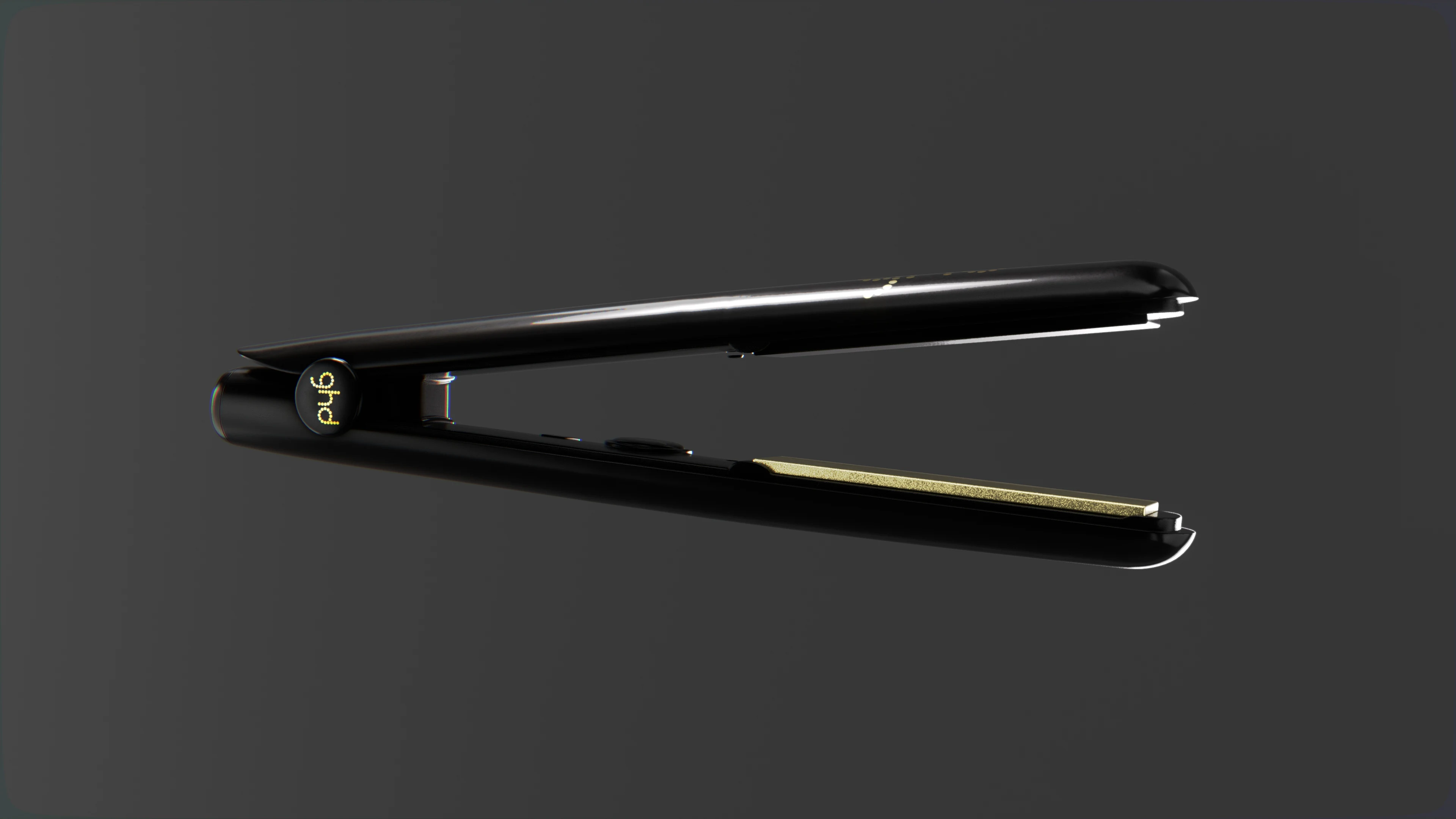 Open ghd Gold hair straightener viewed at an angle, showing the gold inner plates.